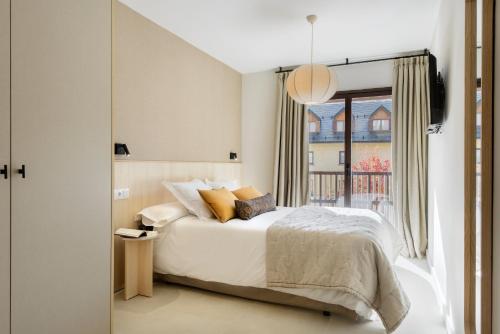 a bedroom with a bed and a window at CiMa Panticosa by BeValle in Panticosa