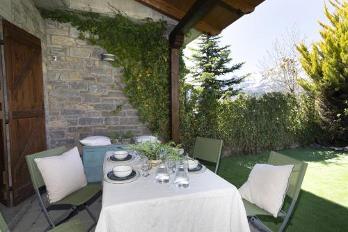 a table with a white table cloth on a patio at El Mirador by BeValle in Panticosa
