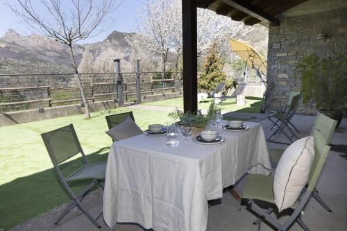 a table with a white table cloth on a patio at El Mirador by BeValle in Panticosa