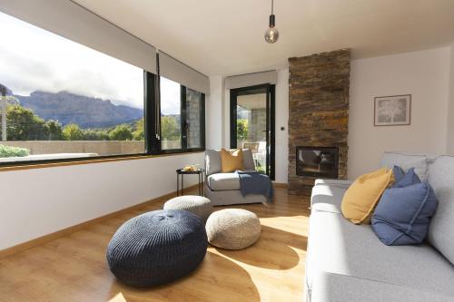 a living room with a couch and a large window at La Ventana de Saras by BeValle in Panticosa