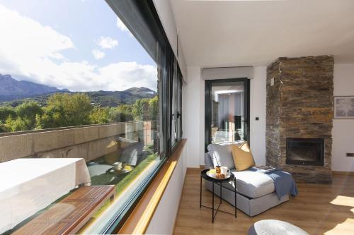 a living room with a large window and a couch at La Ventana de Saras by BeValle in Panticosa