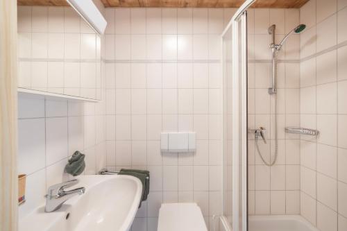 a white bathroom with a sink and a shower at Egg'spresso Gipfelglück in Egg