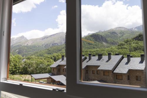a window with a view of a mountain view at El Ciervo de Santa María by BeValle in Panticosa