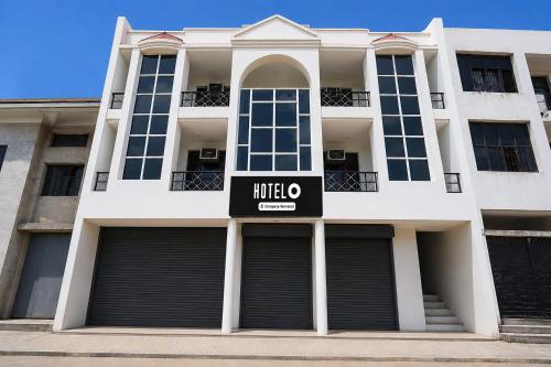 a white building with a mitzo sign on it at Super Hotel O Sector 45 A Chandigarh Formerly Sangam in Chandīgarh