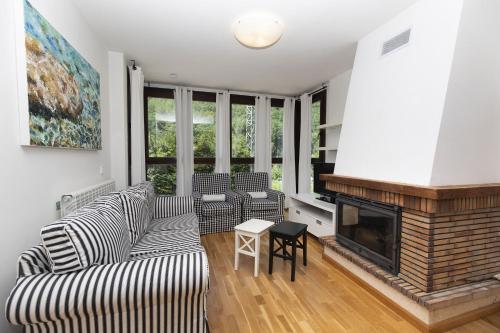 a living room with a couch and a fireplace at Casa Eguzkilore by BeValle in Escarrilla