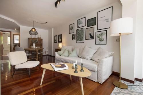 a living room with a white couch and a table at Partacua by BeValle in Tramacastilla de Tena