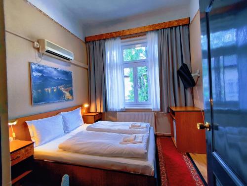 a hotel room with a bed and a window at Villa Kristal Hotel in Budapest