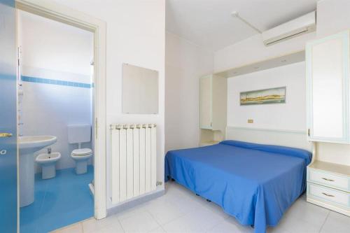 a bedroom with a bed and a sink and a toilet at Hotel Residence Mediterraneo in Diano Marina