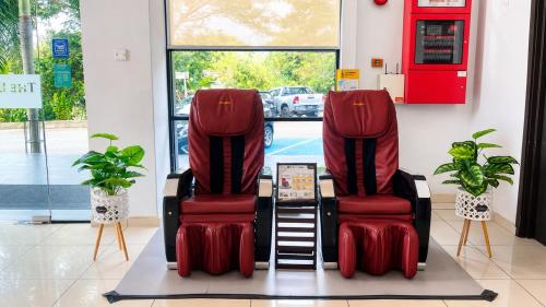 two red chairs sitting in a gas station at The Leverage Lite (Kuantan) in Kuantan