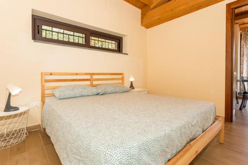 a bedroom with a bed and a window at Casetta delle Rose sull'etna in Viagrande