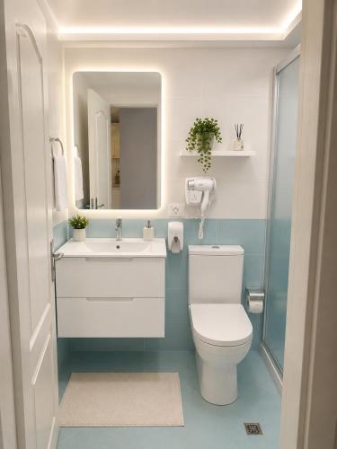 a bathroom with a toilet and a sink and a mirror at Sirel Home in Durrës