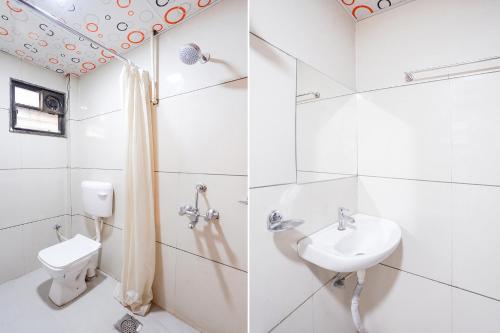 a white bathroom with a sink and a toilet at FabHotel Sunrise Comforts in Pune