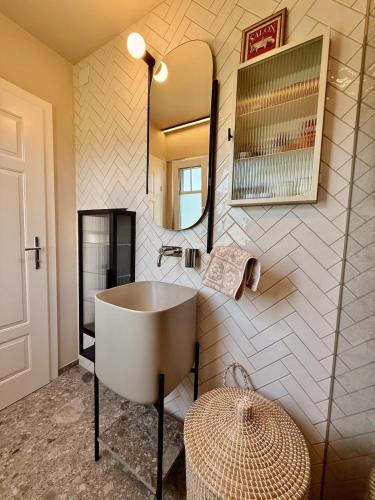 a bathroom with a sink and a mirror at Villa El Jardin Bodensee in Lochau