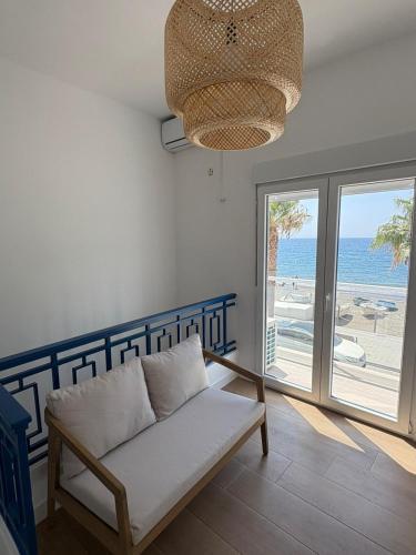 a living room with a couch and a view of the beach at Casa Las Conchas in La Rábita
