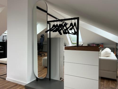 a room with a mirror and a white dresser at Modern Attic Loft in Weisenheim am Sand