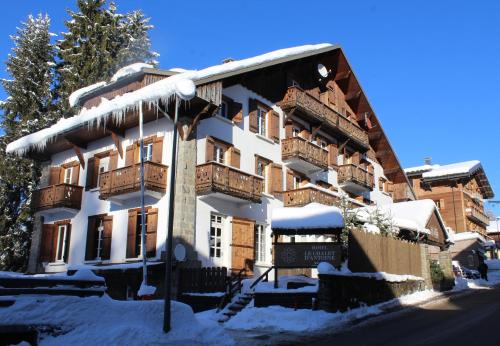 a large building with snow on the side of it at Le Chalet d'Antoine - Centre de Megève in Megève