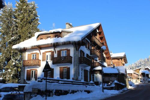 a building with snow on the roof at Le Chalet d'Antoine - Centre de Megève in Megève