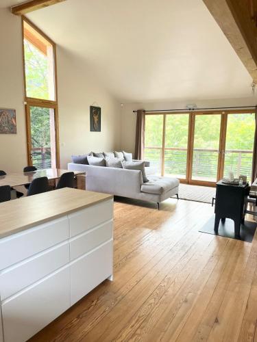 a living room with a couch and a table at Chalet 6 personnes ou studio 2 personnes in Ax-les-Thermes