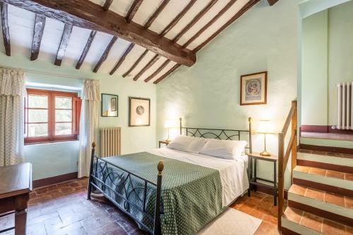 a bedroom with a bed in a room with stairs at Agriturismo Montechiaro in Siena