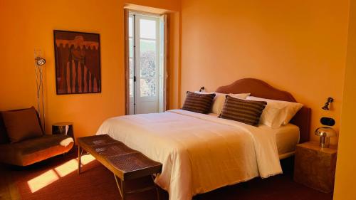 a bedroom with a large bed and a chair at VILLA LORES Adults Only Retreat near Sanxenxo & O Grove in Lores