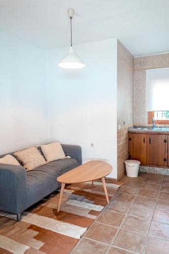 a living room with a couch and a table at Calma house Zahora in Zahora