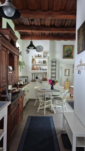 a kitchen with a table and chairs in a room at Kisbagoly Vendégház in Parád