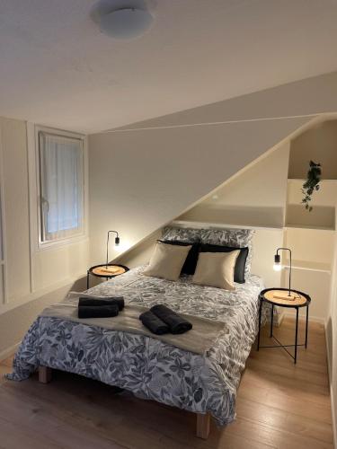 a bedroom with a bed with two lamps on it at L'Atelier 37 - Centre Tours in Tours