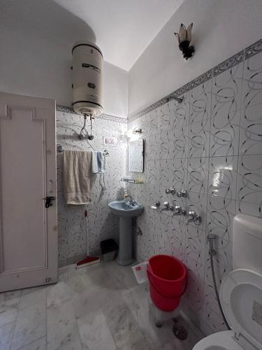 a bathroom with a toilet and a sink at Stay Royal Imperial in Jammu