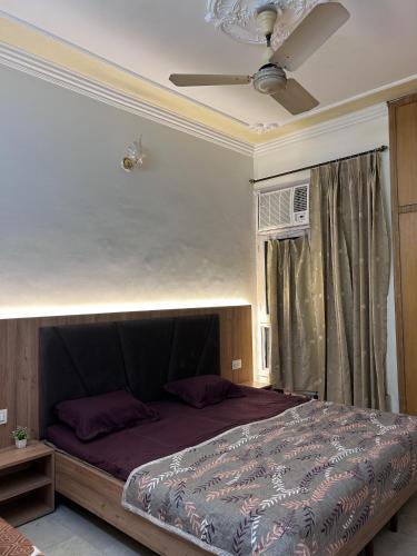 a bedroom with a bed with a ceiling fan at Stay Royal Imperial in Jammu