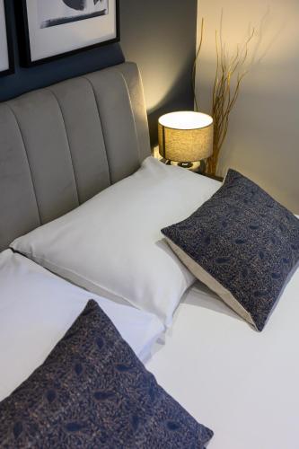 a bed with two pillows on top of it at NIMA Cozy Stay Mlini in Mlini