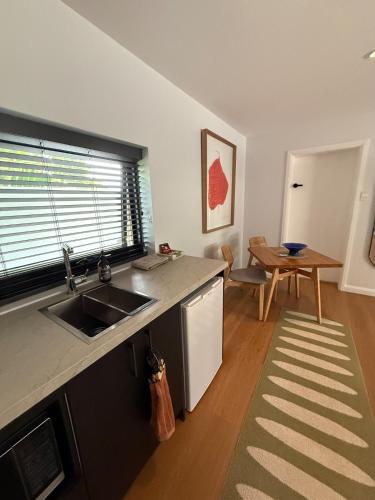 a kitchen with a sink and a table in it at Modern Studio in Sydney