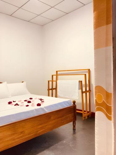 a bedroom with a bed with flowers on it at Aqua Bliss Resort & Villa Bentota in Bentota