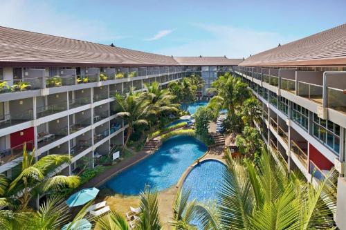 an aerial view of a hotel with a pool and palm trees at GYTf in Cairo