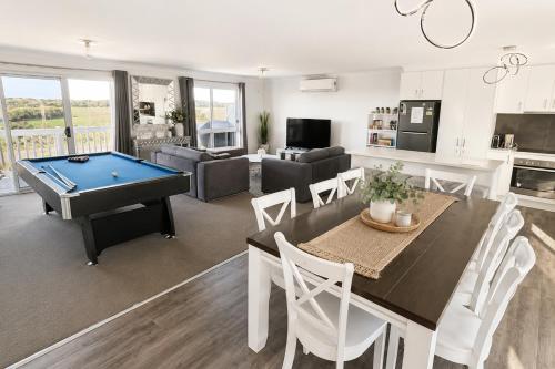 a dining room and living room with a pool table at Ocean Pearl by Ready Set Stay - BYO LINEN & TOWELS in Surf Beach