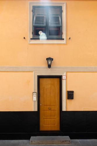 a door in the side of a building with a window at Palazzina Storica al Mare, Rapallo in Rapallo