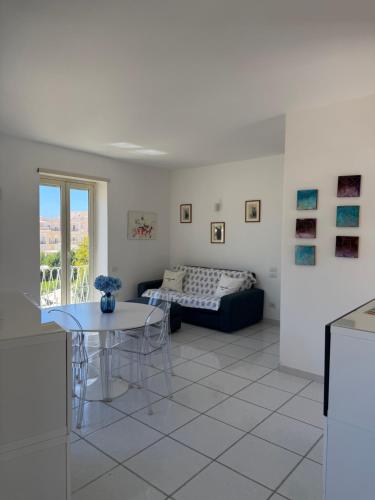 a living room with a table and a couch at Capresella luxury apartment in Capri