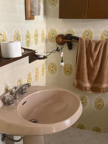 a bathroom with a sink and a towel at Scaramella room s in Salerno