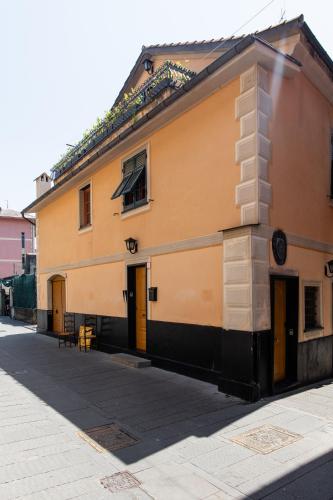 a yellow building on the side of a street at Palazzina Storica al Mare, Rapallo in Rapallo