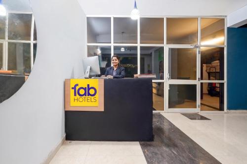 a man sitting at a desk in an office at Fabhotel Namaskar - Nr Udayagiri and Khandagiri caves in Bhubaneshwar