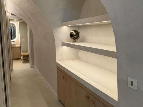 a hallway with shelves and an archway in a home at Mercure Nice Marché Aux Fleurs in Nice