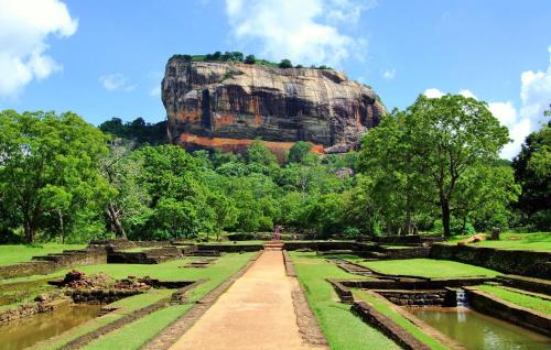 a view of the ruins of a rock formation at Sigiriya Peacock Homestay in Sigiriya