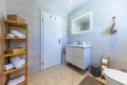 a bathroom with a sink and a mirror at NIMA Cozy Stay Mlini in Mlini