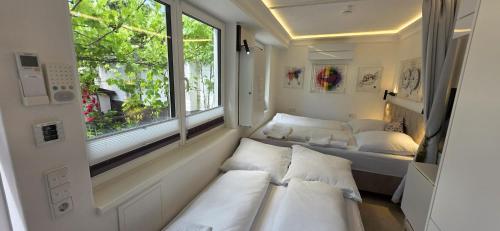a small room with two beds and a window at Cozy Tiny-House - ComfyHome Apartments in Stuttgart