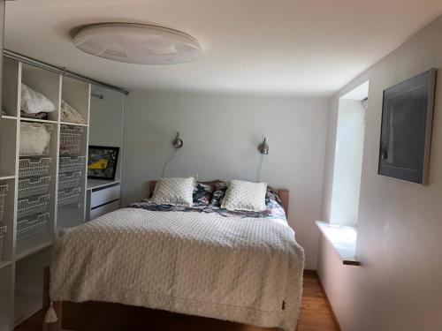 a bedroom with a bed and a tv on a wall at Aavik Apartment in Kuressaare