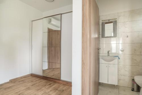 a bathroom with a shower and a toilet and a sink at Perseus in Cape Sarakiniko in Argostoli