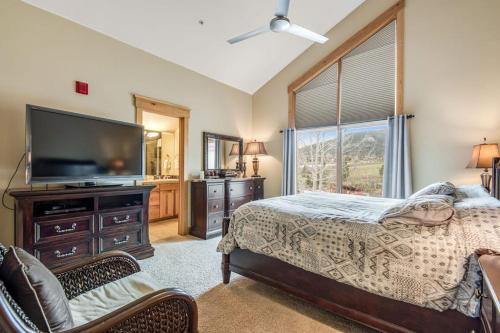 a bedroom with a bed and a flat screen tv at Dillon Ridge Retreat in Dillon