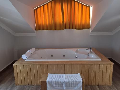 a bath tub in a bathroom with a window at Villa Bağ Tepesi in Fethiye