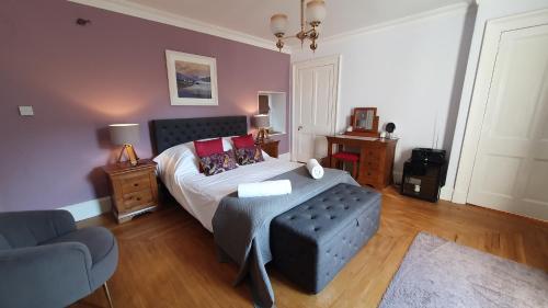 a bedroom with a bed and a couch at Tirindrish House B&B in Spean Bridge