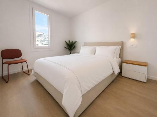 a bedroom with a large white bed and a chair at YBH Ocean Boutique in Vigo
