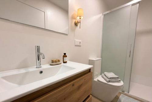 a white bathroom with a sink and a toilet at YBH Ocean Boutique in Vigo